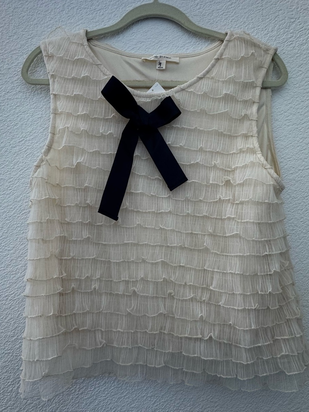 Sleeveless Cream Ruffle Top with Black Bow from Anthropologie